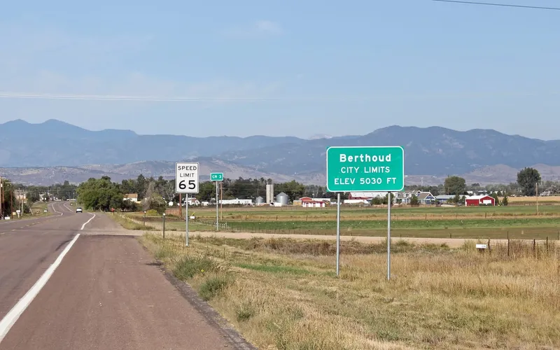 The Berthoud town-limits sign on the road in from the east, with the plains behind it