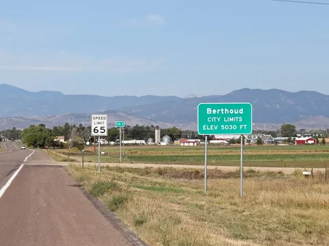 The Berthoud town-limits sign on the road in from the east, with the plains behind it